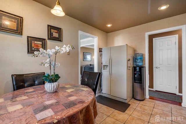 dining area with light tile patterned flooring and recessed lighting