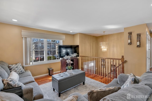 living room featuring wood finished floors, a chandelier, recessed lighting, and baseboards