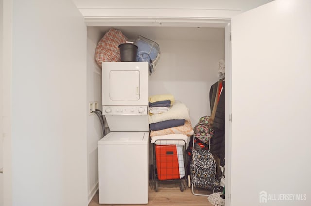 1 Carriage City Plz Unit 509, Rahway, NJ 07065 - laundry room featuring stacked washer / dryer and wood finished floors