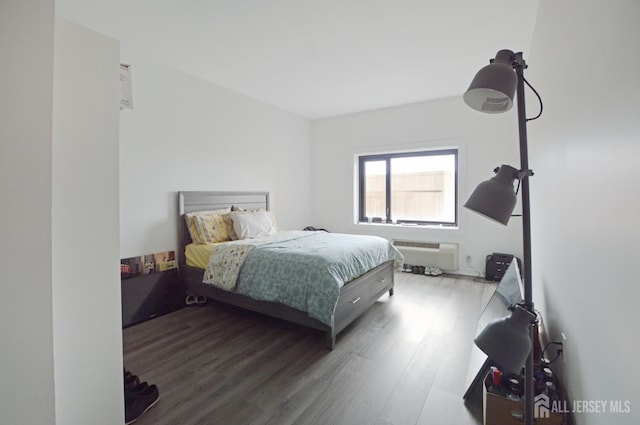 1 Carriage City Plz Unit 509, Rahway, NJ 07065 - bedroom with wood finished floors and a wall mounted AC