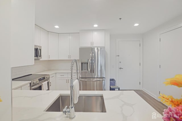 1 Carriage City Plz Unit 509, Rahway, NJ 07065 - kitchen with stainless steel appliances, light stone countertops, white cabinets, recessed lighting, and wood finished floors