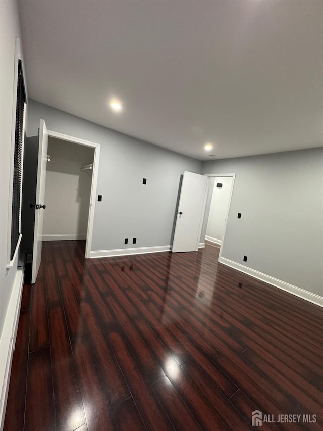 spare room with dark hardwood / wood-style floors