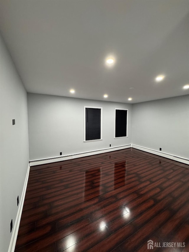 unfurnished room with dark hardwood / wood-style flooring