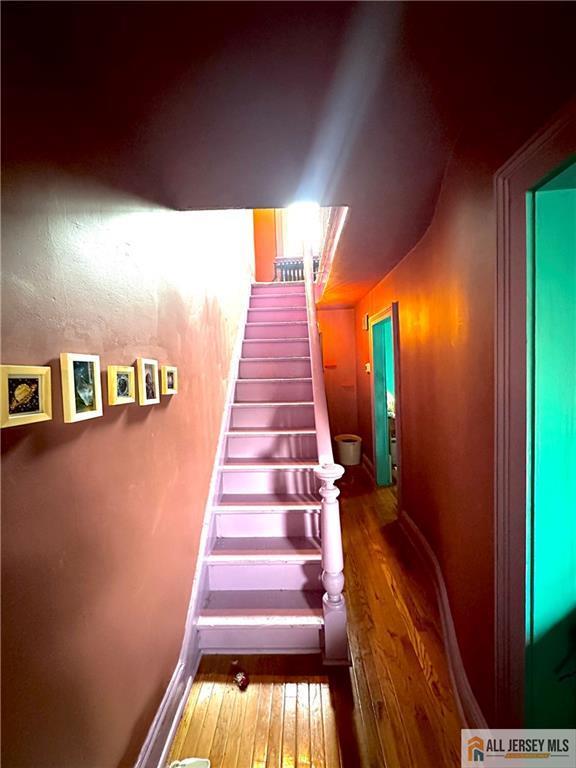 21 Alexander St, New Brunswick, NJ 08901 - stairway with hardwood / wood-style floors and baseboards
