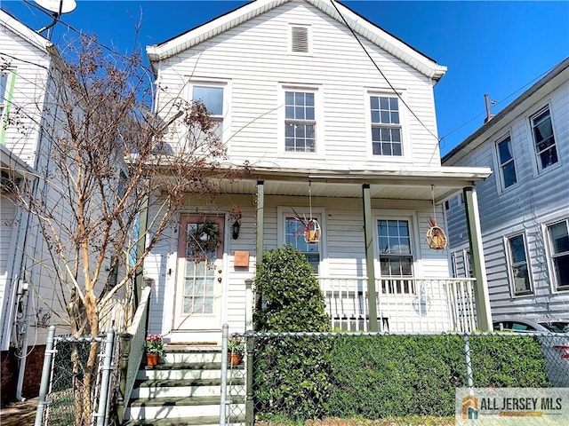 21 Alexander St, New Brunswick, NJ 08901 - view of front of property featuring covered porch, a fenced front yard, and a gate