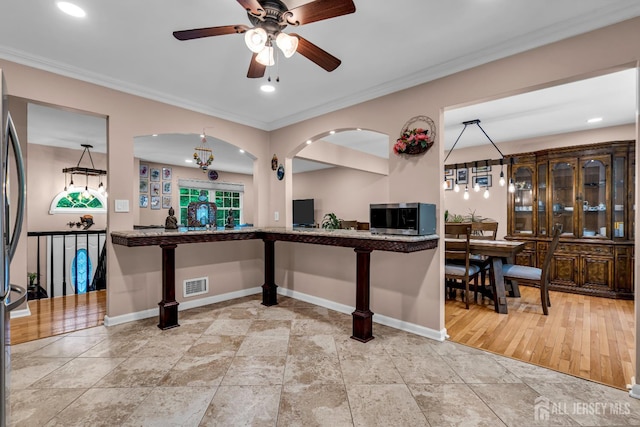 230 New Rd, South Brunswick, NJ 08852 - kitchen with crown molding, stainless steel microwave, a ceiling fan, and recessed lighting