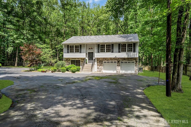 230 New Rd, South Brunswick, NJ 08852 - bi-level home featuring stone siding, driveway, and a garage