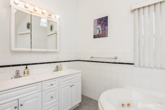 63 Clinton Ave, Keasbey, NJ 08832 - bathroom featuring tile walls, double vanity, a whirlpool tub, and wainscoting