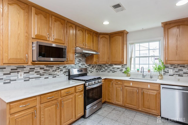 63 Clinton Ave, Keasbey, NJ 08832 - kitchen with appliances with stainless steel finishes, under cabinet range hood, light countertops, decorative backsplash, and granite tiled floors