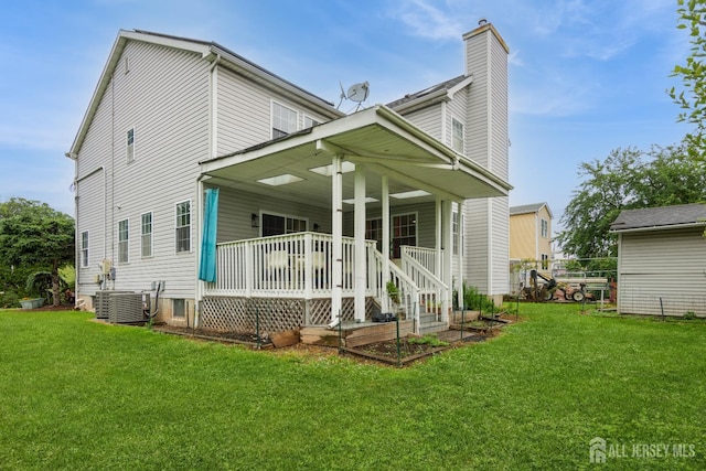 63 Clinton Ave, Keasbey, NJ 08832 - back of house featuring a porch, a lawn, and a chimney