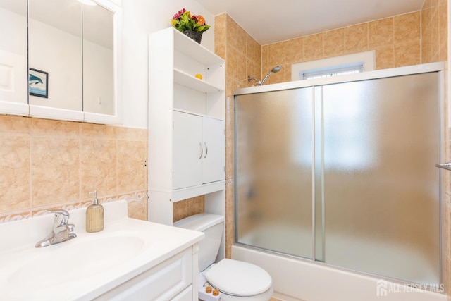 63 Clinton Ave, Keasbey, NJ 08832 - bathroom with vanity, combined bath / shower with glass door, tile walls, and tasteful backsplash