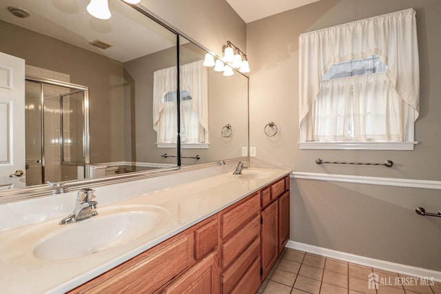 full bathroom with a sink, visible vents, double vanity, and tile patterned flooring