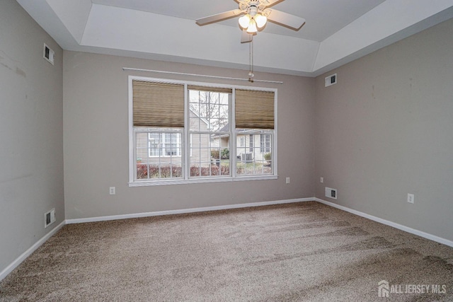 carpeted empty room featuring visible vents, baseboards, and a ceiling fan