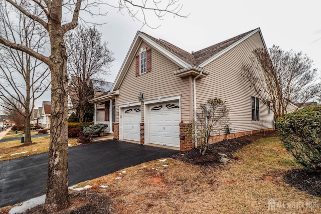 view of property exterior with aphalt driveway