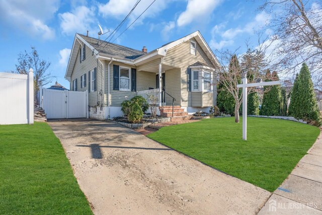 view of front of house featuring a front yard and covered porch