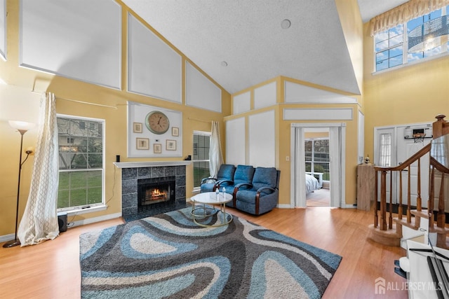 8 Carlisle Ct, Old Bridge, NJ 08857 - living room with high vaulted ceiling, wood finished floors, a fireplace, and stairway