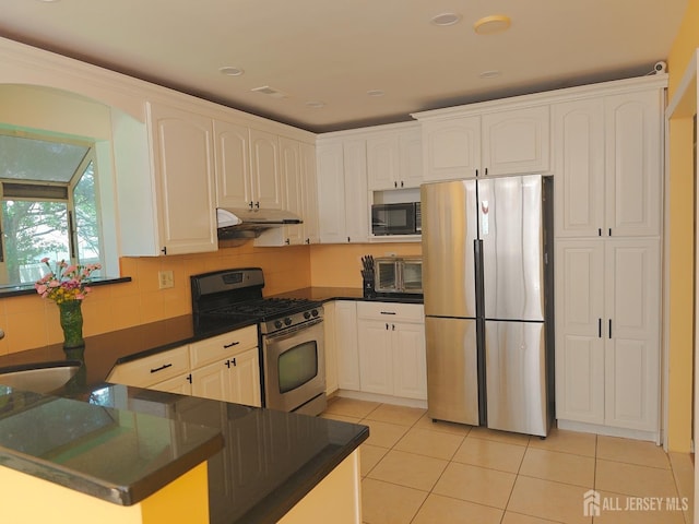 8 Carlisle Ct, Old Bridge, NJ 08857 - kitchen featuring stainless steel appliances, dark countertops, light tile patterned flooring, under cabinet range hood, and white cabinets