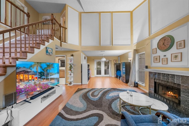 8 Carlisle Ct, Old Bridge, NJ 08857 - living room with a tiled fireplace, wood finished floors, a towering ceiling, and stairway