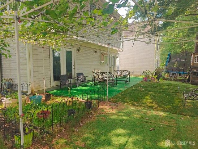 8 Carlisle Ct, Old Bridge, NJ 08857 - view of green lawn featuring a trampoline