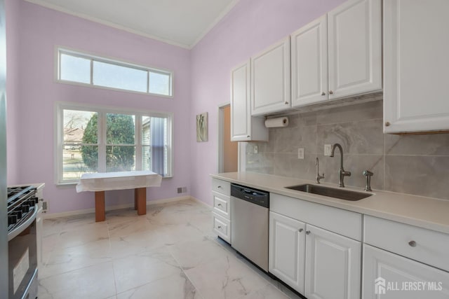 kitchen with stainless steel dishwasher, baseboards, a sink, and gas range