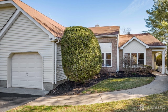 view of front of house with brick siding and a garage