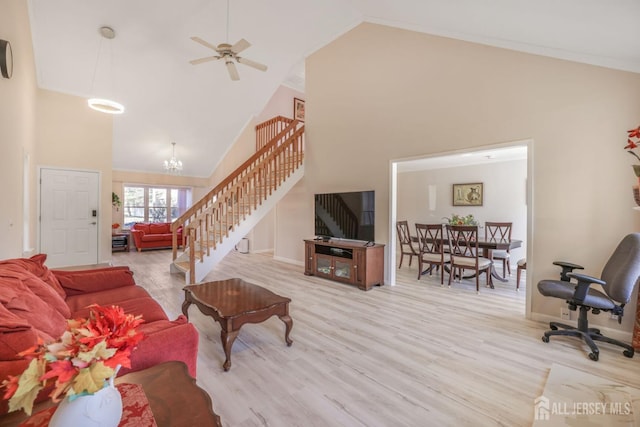living room featuring wood finished floors, ceiling fan with notable chandelier, high vaulted ceiling, stairway, and baseboards