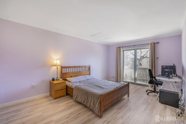 bedroom featuring light wood-style flooring, baseboards, and access to exterior