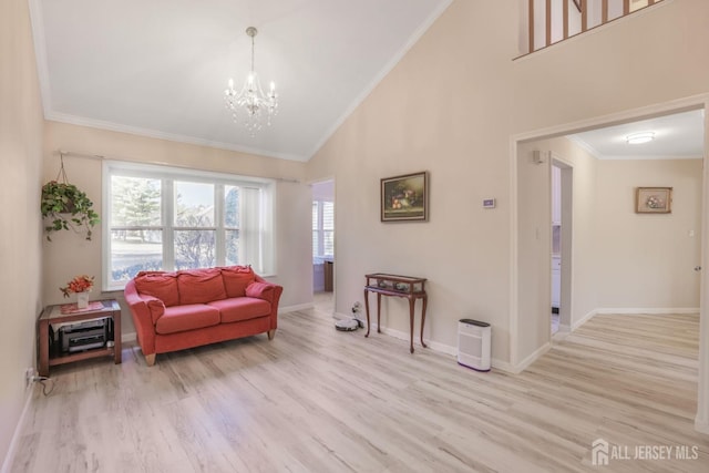 living room with wood finished floors, ornamental molding, high vaulted ceiling, an inviting chandelier, and baseboards