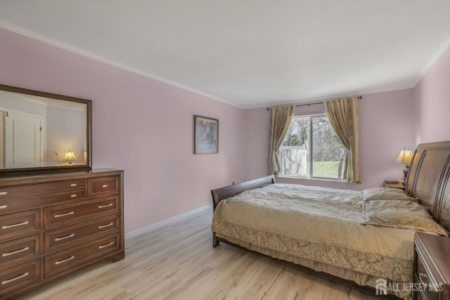 bedroom with baseboards, ornamental molding, and light wood-style flooring