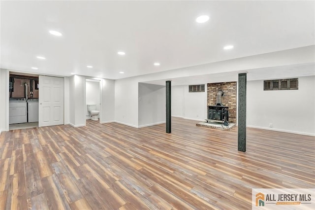 440 E Ave, Sewaren, NJ 07077 - finished below grade area featuring separate washer and dryer, light wood-style floors, a wood stove, and recessed lighting