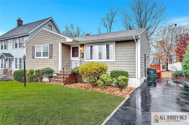 440 E Ave, Sewaren, NJ 07077 - view of front of house with a chimney and driveway