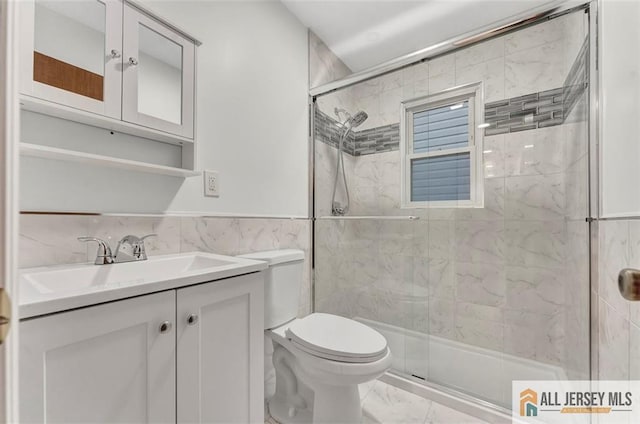 440 E Ave, Sewaren, NJ 07077 - bathroom with marble finish floors, tile walls, a stall shower, vanity, and a wainscoted wall