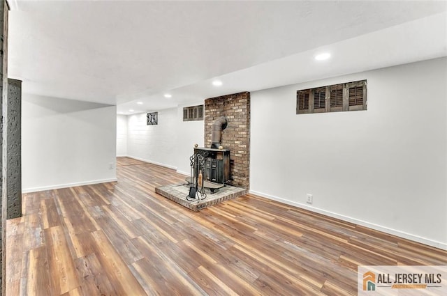 440 E Ave, Sewaren, NJ 07077 - finished basement with a wood stove, wood finished floors, and recessed lighting