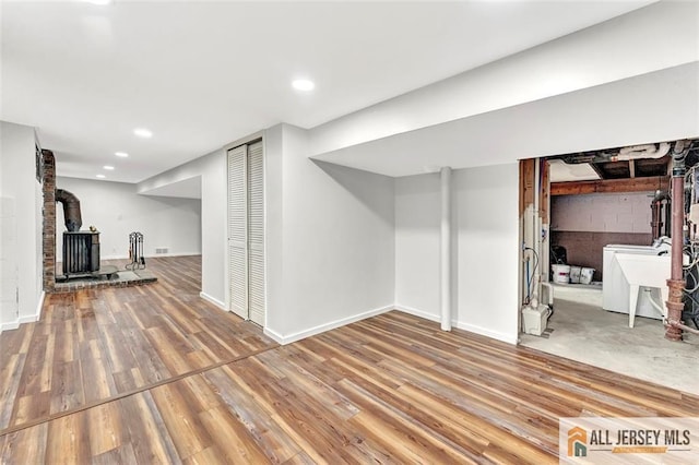 440 E Ave, Sewaren, NJ 07077 - finished below grade area with washer / clothes dryer, a wood stove, wood finished floors, and recessed lighting