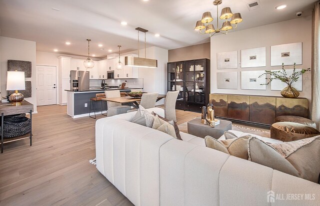 1314 Parker Blvd, West Windsor, NJ 08550 - living area with light wood-style floors, a chandelier, and recessed lighting