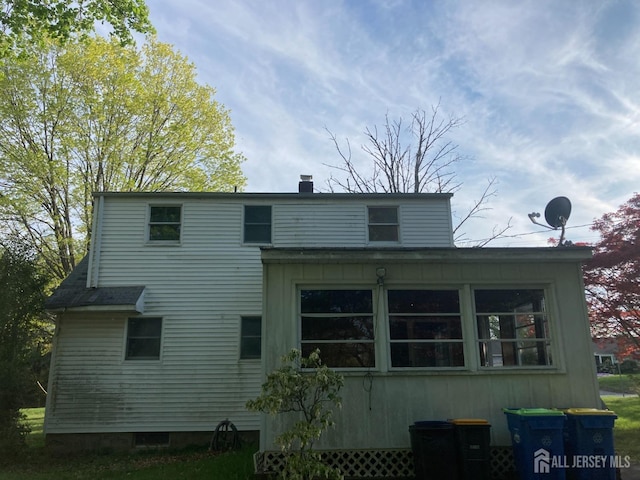 rear view of property with a chimney