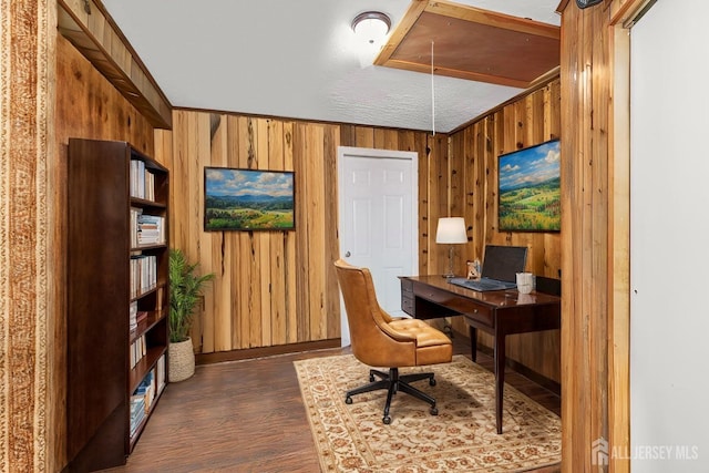 office with attic access, dark wood finished floors, crown molding, and wood walls