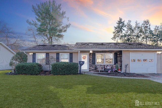 ranch-style house featuring a garage, stone siding, and a front lawn