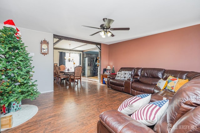 living area featuring dark wood-style floors and ceiling fan with notable chandelier