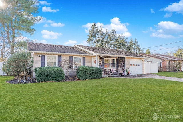 ranch-style house featuring a garage and a front yard