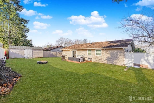 back of property featuring a storage shed, a garden, a fenced backyard, a yard, and an outdoor structure