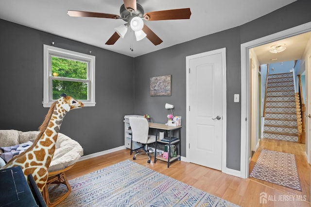 office area featuring wood finished floors, a ceiling fan, and baseboards