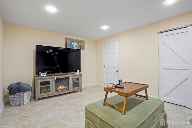 living area with baseboards and recessed lighting
