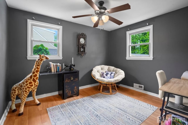 office with wood finished floors, a ceiling fan, and baseboards
