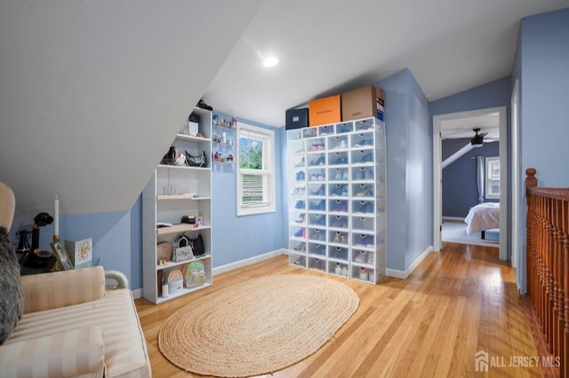 sitting room with light wood-style floors, lofted ceiling, baseboards, and ceiling fan