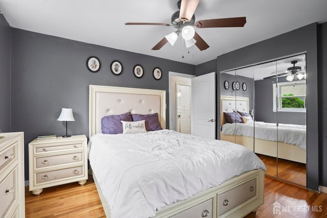 bedroom featuring a closet, wood finished floors, and ceiling fan