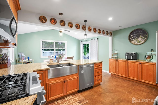 kitchen featuring stainless steel appliances, light stone counters, a sink, lofted ceiling, and brown cabinets