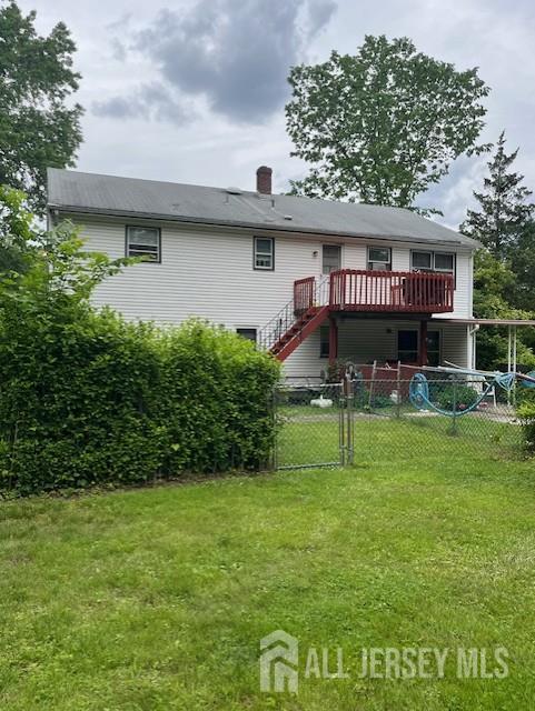 1436 Thomas Ave, North Brunswick, NJ 08902 - rear view of house featuring a wooden deck, stairway, a chimney, and a gate