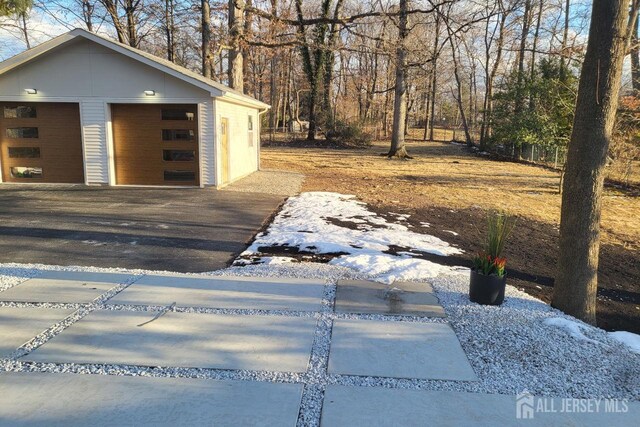 exterior space featuring a garage and an outdoor structure