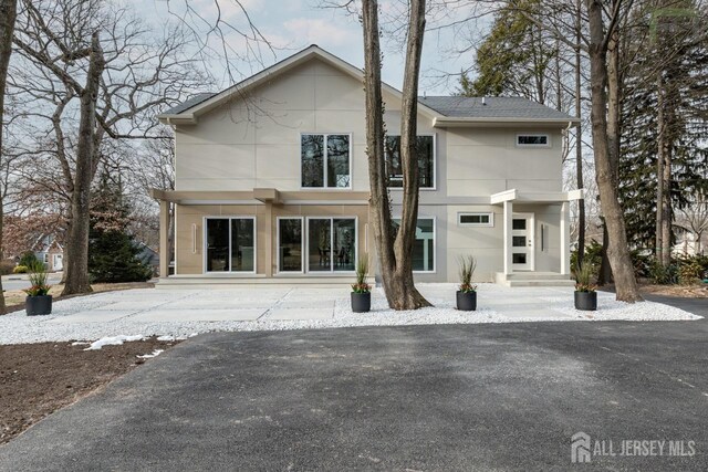 back of property featuring stucco siding